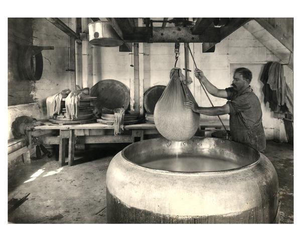 A small old dairy factory and a man making curd
